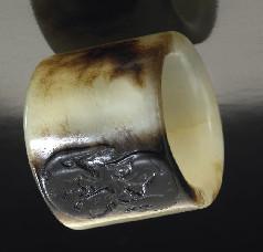 374 Chinese Qing carved jade archer's ring, depicting double badgers.