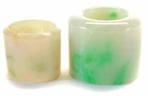 Lot 6031 Lot 6032 Lot 6033 6031 Two Jadeite Archer s Rings Comprising a thickly sectioned ring displaying patches of green inclusions, and a thinly sectioned ring displaying russet and moss-green