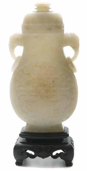 Lot 6038 Lot 6039 6038 A Jade Archaistic Vase and Cover Of compressed baluster form, carved in low relief to each side of the body with two archaistic dragons, the waisted neck with a pair of