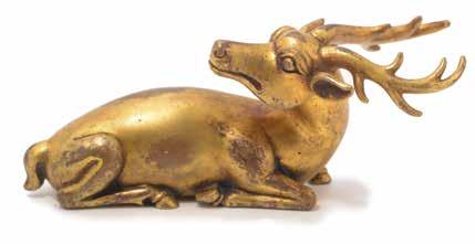 6094 A Gilt-Bronze Stag Form Weight Chenghua Mark Shown in a recumbent position with legs tucked underneath its body and head turned backward, designed with a pair of gently curing antlers and