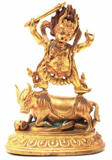 6110 A Gilt-Bronze Figure of Yama Qing Dynasty Yama shown striding in alidhasana on the back of a buffalo over a prostrated figure on a lotus base, his hands raised in vitarka mudra, the base sealed