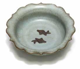 Chinese Ceramics Lot 6131 Lot 6130 6130 A Guan Ware Type Dish Lot 6132 The small dish with deep walls rising to a foliated rim, molded with two unglazed fish in opposition to the floor, covered