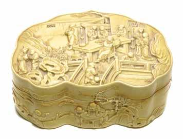 Lot 6148 6148 A Yellow-Glazed Seal Paste Box Qianlong Mark The biscuit fired container of ruyi-shape, the lid with a molded decoration of figures in a garden, the sides of the box with boys at play,