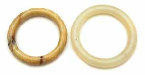 yellowish tone; the second is a plain bangle of light celadon white hue with russet inclusions. Widest: 3 1/4 inches (8.