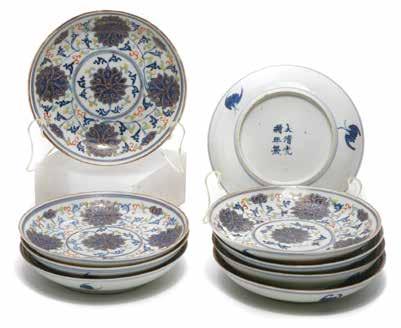 6162 Nine Underglaze Blue and Enameled Saucers Guangxu Marks The shallow interior decorated with five stylized lotus flowers in underglaze blue and finished in gilt, the exterior featuring three