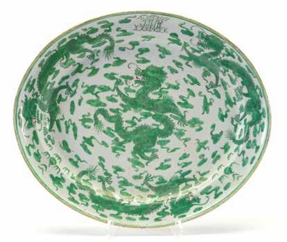 6170 A Chinese Export Famille Verte Platter 19th Century The shallow ovoid platter painted in green enamel with four sinuous five-clawed dragons flying