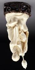 615 Chinese carved ivory lohan, regulations prior to bidding) seated on a rock,