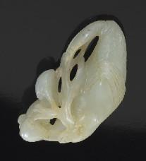 484 Chinese Qing carved white jade bird with peaches in its mouth.
