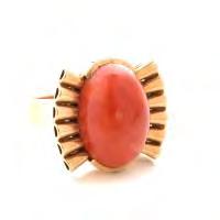 17 *Retro Coral, 14k Yellow Gold Ring. Featuring one oval shaped red coral cabochon measuring approximately 19.7 x 14.2 mm, set in a 14k yellow gold retro fan motif mounting.