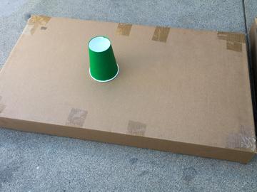 The two halves of the box are laid end to end for a longer green. You may need to cut, fold, and join parts to construct a similar green, depending on your materials.