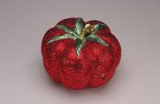 Additionally, Judith Leiber s 1994 Swarovski crystal-encrusted minaudière in the shape of a tomato was designed to be a display of glamour and imagination.