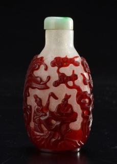 0100 BALUSTER SHAPE BUBBLES WHITE GLASS SNUFF BOTTLE DECORATED WITH RED OVERLAY representing figures and servants under a pine tree and cherry blossoms. Jadeite stopper.