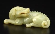 0044 CELADON NEPHRITE LYING DOG, head turned to the back. L: 15cm - 6" 0045 GU SHAPE WHITE NEPHRITE VASE slightly carved with Taotie masks and cicadas.