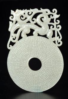 E: 800 / 1000 0067-G AN OPEN WORK WHITE NEPHRITE PENDANT of floral geometric form with central moving wheel.