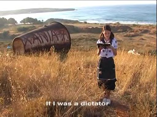 In the middle of a Greek field, the artist, dressed in traditional clothes, fakes a performance by stealing the words of 1930s singer Roza Eskenazi.