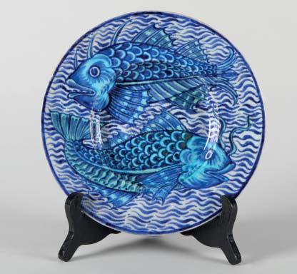 3 40 William De Morgan glazed earthen ware plate, decorated with two fish on a blue