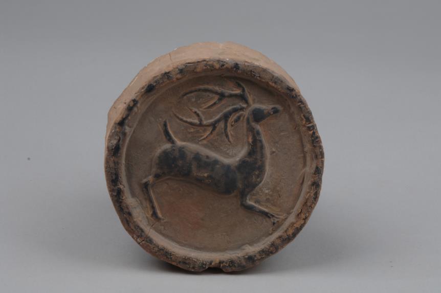 99. Inventory number: 002958 Object title: Roof- tile end with running deer pattern Dimensions: Diameter 13.2cm; Thickness 1.97cm Material: Pottery Date made: Warring States Period (c.