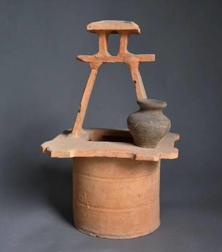 119. Inventory number: M166:23 Object title: Model of a well with small jar. Dimensions: Height 35cm; Diameter of mouth 9.7cm; Diameter of base 15.