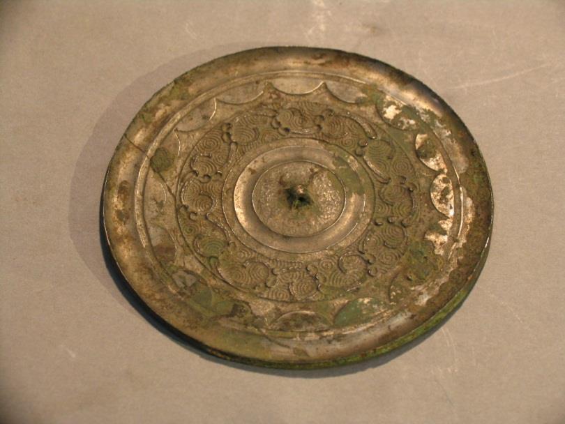 32. Inventory number: 7211 Object title: Mirror with panchi pattern (a dragon-like animal) Dimension: Diameter 11.5cm Material: Bronze Date made: Warring States Period (c.