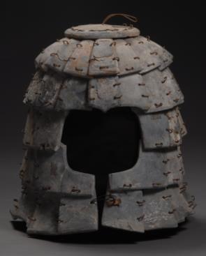49. Inventory number: JZ10-1 Object title: Helmet Dimensions: Height 38cm; Width 21cm Material: Polished and drilled rectangular stone pieces with copper wire Date made: Qin Period (221 206 BCE)
