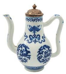 543 A Chinese blue and white wine ewer of baluster form with ogee loop handle and long curved spout, painted with chilong, bats and swastika motifs, Kangxi, later metal cover and mount, 15.