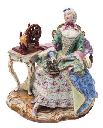 * 500-700 642 A Meissen porcelain figure of The Good House Keeper modelled after the original by Kaendler seated wearing a headscarf, floral dress and cloak holding a bible beside a