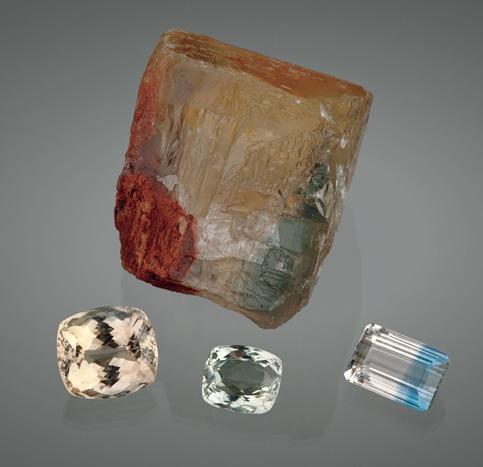 The crystal has a distinct blue zone in the lower right (and an iron stain on the lower left); the cut stones weigh 25.9 51.7 ct. Courtesy of Gemological Center; photo by Robert Weldon.