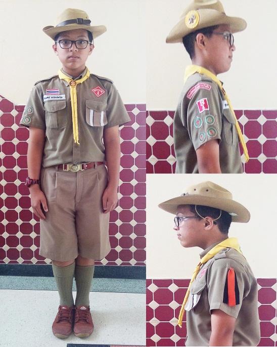 Primary 4-6 Scout Uniform Boys Khaki short-sleeve shirt and shorts, plus: Khaki Baden-Powell scout hat with brass Boy Scouts hat badge (mounted on plastic yellow rosette) Triangular yellow