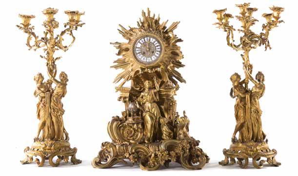 swastika and diamond decoration, 9 in H Est $1500-2000 1293 Continental onyx and gilt-metal clock garniture second half-19th century; portico clock with four columnar supports, enamel face on shaped