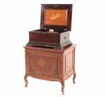 DECORATIONS 1303 1303a Stella Swiss music box, stand, and discs dated 1897; rosewood casket-form case, single comb, #53773, 12 in H, 27 in W, 21 in D and mahogany cabinet stand, with single paneled