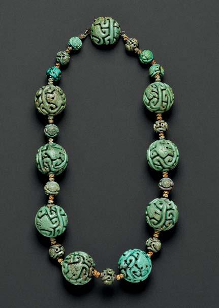 275 275. Chinese Carved Turquoise Bead Necklace, composed of eight large beads with Chinese motifs, joined by carved beads, approx. 23.00 and 10.