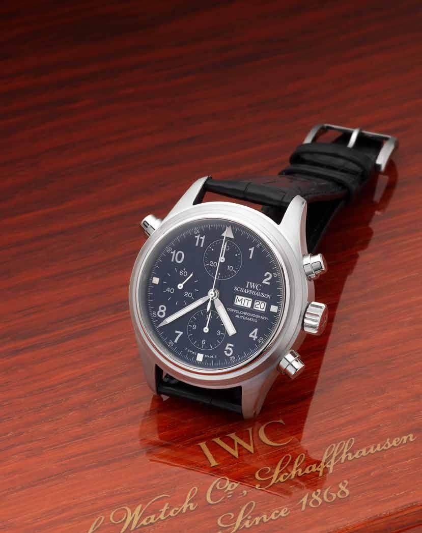 263 IWC. A very fine round button split-seconds chronograph with day and date and platinum IWC buckle together with fitted wooden box and booklet. Der Doppelchronograph, No. 115, Case No.