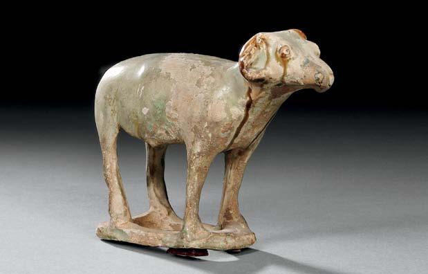 49 Pottery Standing Ram, China, Tang dynastystyle, the horned ram standing on four legs attached to a rectangular base, traces of pale green and brown glaze,