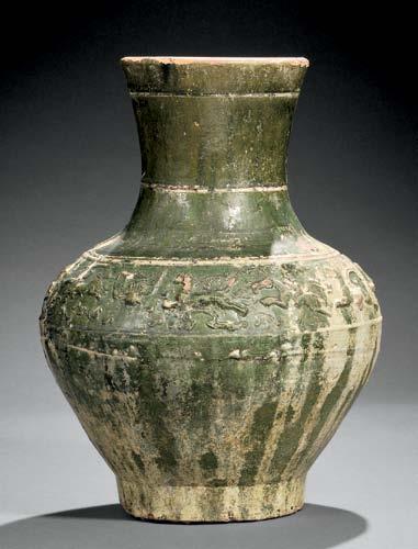 54 55 54 Green-glazed Pottery Vase, China, Han dynasty-style, Hu-form, with a band of molded lions, horses, hunters, and other animals,