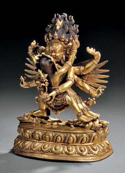 65 66 65 Gilt-bronze Figure of Yamantaka and Vajravetali, Tibet, 19th century, depicting Yamantaka with three faces, six arms, and four feet, holding Vajravetali, and stepping on four figures on top