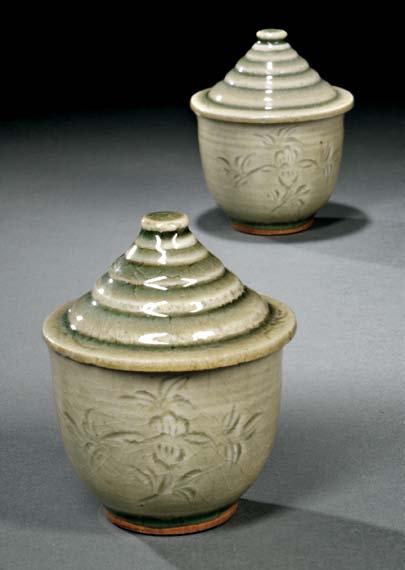 $500-700 98 Pair of Celadon Cups with Covers, China, Song dynasty, Yaozhou ware-style, cylindrical form with slightly flared rim and rounded bottom, unglazed rim and foot ring, decorated with two