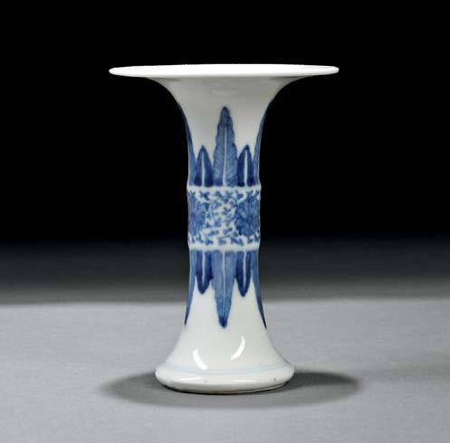 108 Blue and White Gu Vase, China, late Qing dynasty, with widely flared mouth, resting on an unglazed foot ring, the body with a raised band in the center painted with three lotus flowers, and