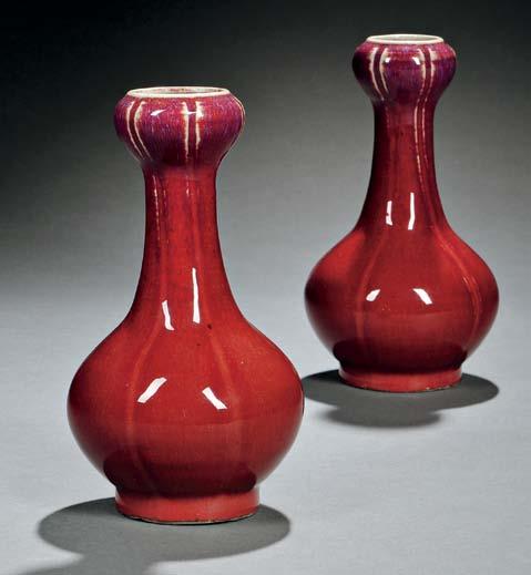 117 116 116 Pair of Flambé Vases, China, Qing dynasty, garlic-head form with long neck and six-lobed bulbous jar-shape mouth with lipped rim, resting on short straight foot, the copper red glaze with