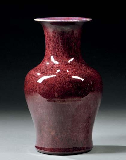 $400-600 119 Large Mottled Flambé Vase, China, late Qing dynasty, baluster form with a trumpet-shaped mouth, resting on a raised foot, the mottled deep wine glaze stopped near base, the flared mouth
