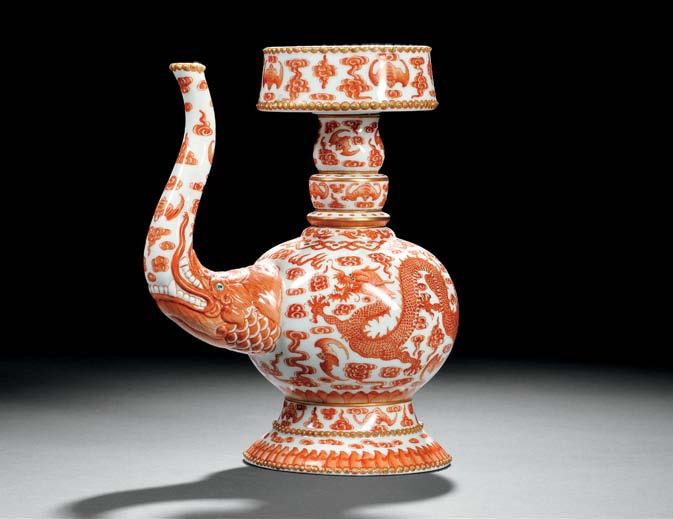 127 127 Iron Red Overglazed Enamel Porcelain Ewer, China, Qing dynasty, Tibetan bumpashape, with S-form spout issuing from the jaw of the molded makara with enameled details and the eyes in