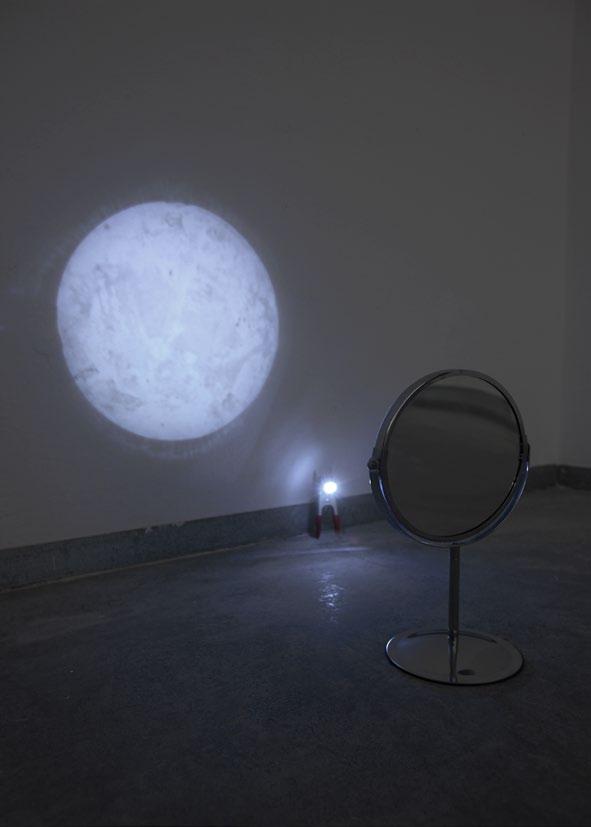 Moon Beard mirror, clamp, LED battery, sodium chloride Variable dimensions 2009 A small LED battery, held up by a clamp, points to a shaving mirror.