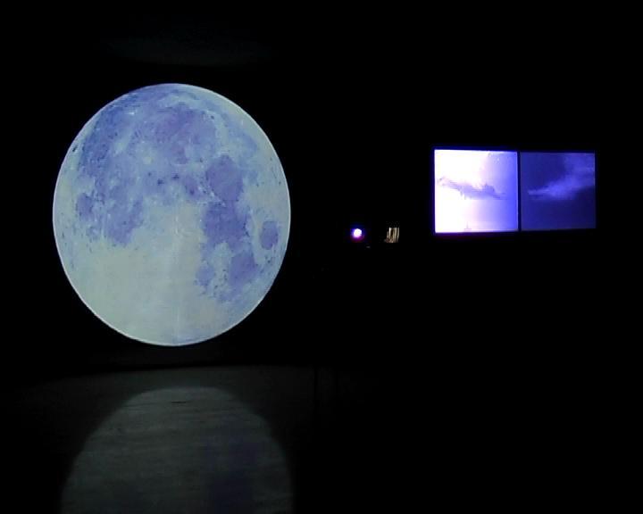 COMPRESSION, video environment 2006 Round projection surface (R=2,5m), transparent textile fabric (3,5 x 2,8m), two plastic plates (25 x 32cm), DVD projections of the full Moon, sea wave and a diver,