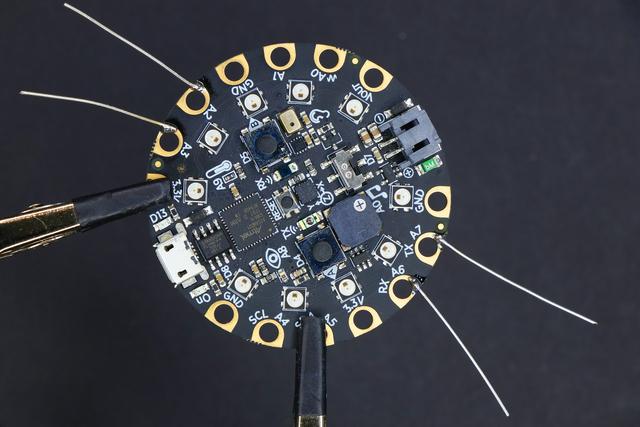 Assemble the Badge Solder Wires to the CPX Start by adding small wires to the four pins on the Circuit Playground Express that will be our conductive inputs.