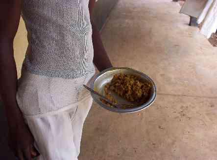 AN INMATE IN GHANIAN PRISON DISPLAYING MEAL