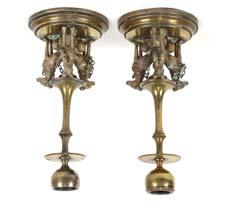 gilded brass candlesticks, decorated with figures of three seated dogs to the circular stepped bases, 19cm high 50-80 263 A 20th Century automaton, depicting a bird in a cage, the fabric covered base