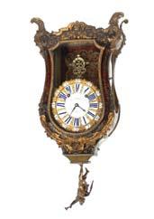 394 A large 18th Century French bracket clock, in the manner of Boulle, having tortoise shell and cut brass inlaid decoration with ormolu mounts, the circular enamel Roman numeral dial signed Guiot,