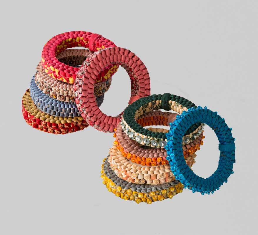 ROUND BRACELET Hand cut strips of fabric are twisted and knotted to create a textile sculpture.