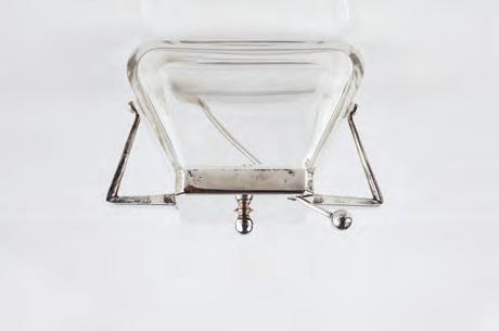 AN EARLY 20TH CENTURY GLASS LEMONADE JUG, with silver plated mounts and handle, having slice cut decoration, central ice reservoir and hinged cover, 34cm high 80-120 (plus 24% BP*) 542.