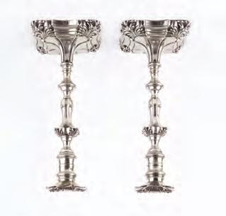 A PAIR OF VICTORIAN SILVER CANDLESTICKS, with knopped and shaped baluster stems, on shaped and lobed square section bases by Hawkesworth, Eyre & Co (James Kebberling