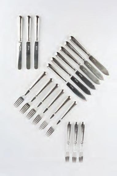 628. A SET OF SIX SILVER FISH KNIVES AND FORKS with three matching dessert knives and forks by Goldsmiths and Silversmiths Co Ltd, London